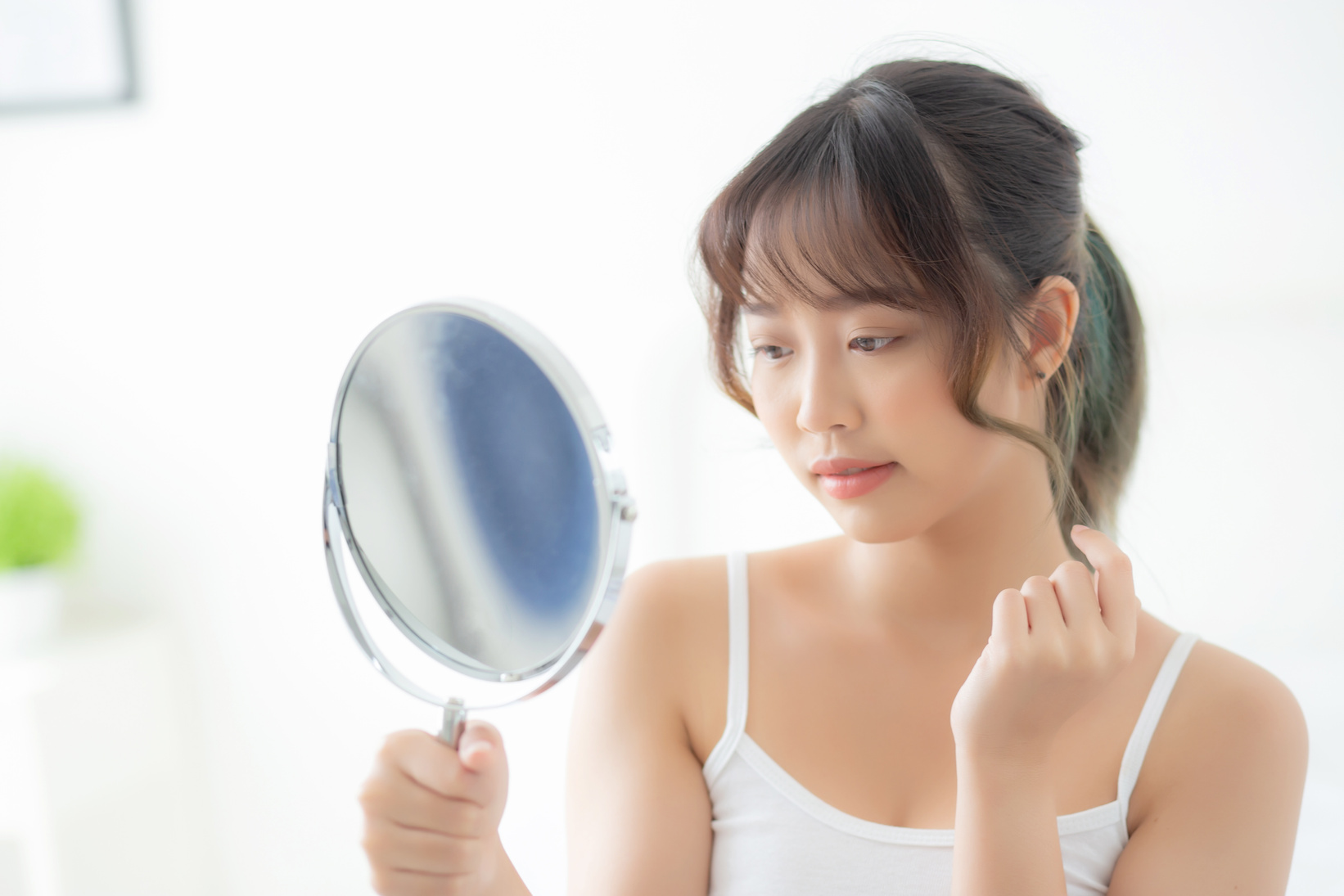 Woman Looking at Herself in the Mirror 